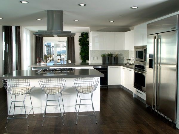 A modern kitchen with a large island and stainless steel appliances.