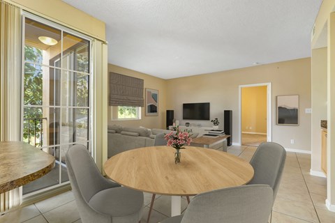 a dining room with a table and chairs and a living room