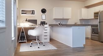 a home office with a desk and a chair in a kitchen