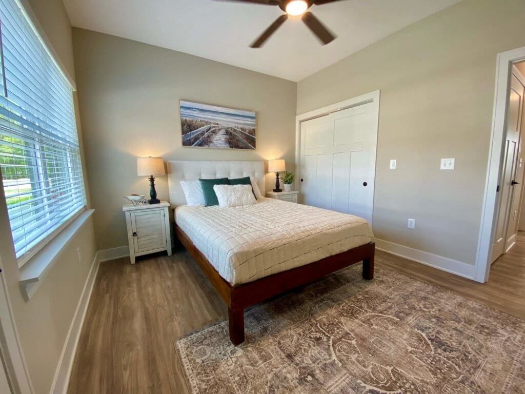 a bedroom with a bed and a ceiling fan
