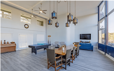 a large room with a ping pong table and a flat screen tv