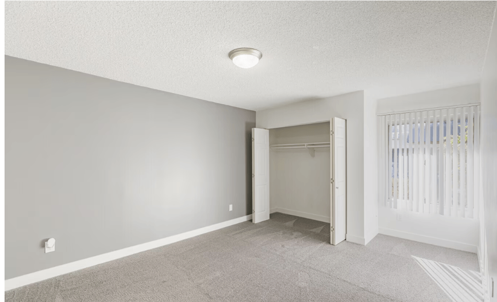 Two BR Apartments in El Cajon CA - Ivanhoe Village - Unfurnished Bedroom with Carpeting, Large Closet, and Window