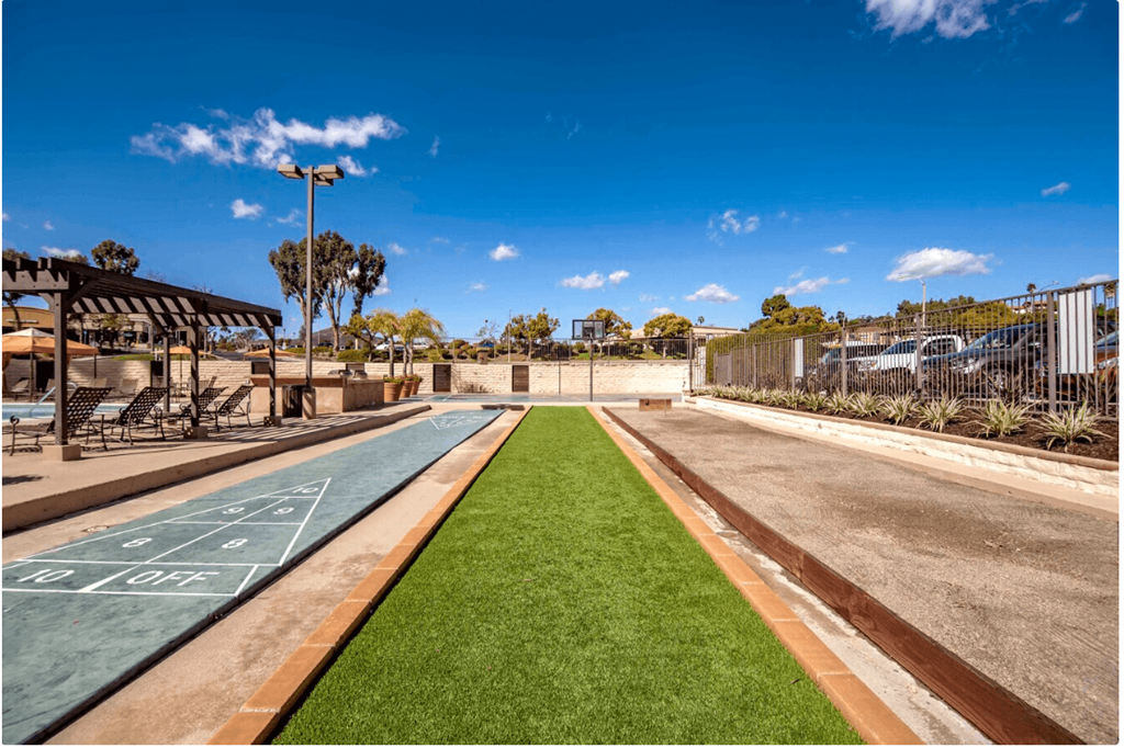 a basketball court in a park next to a road