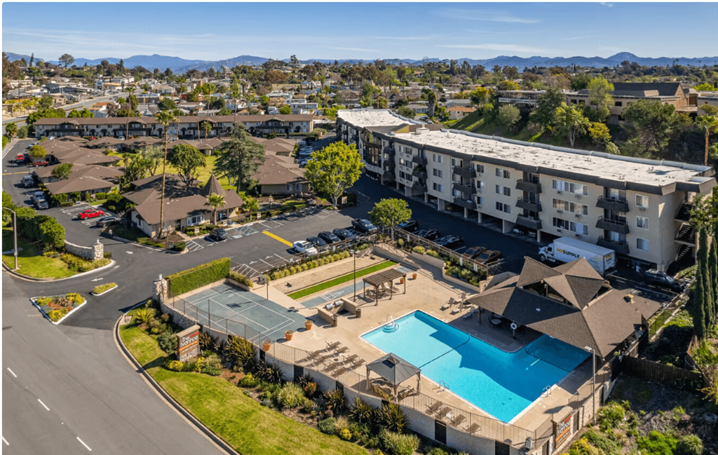Apartments for Rent in El Cajon CA - Ivanhoe Village - Aerial View of Outdoor Amenities Including the Pool, Basketball Court, and Horse Shoes as Well as the Apartment Building and Parking Lot