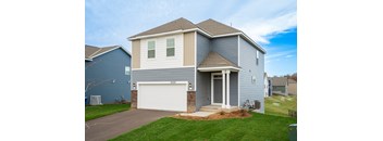 A house with a white garage door and a grey roof.