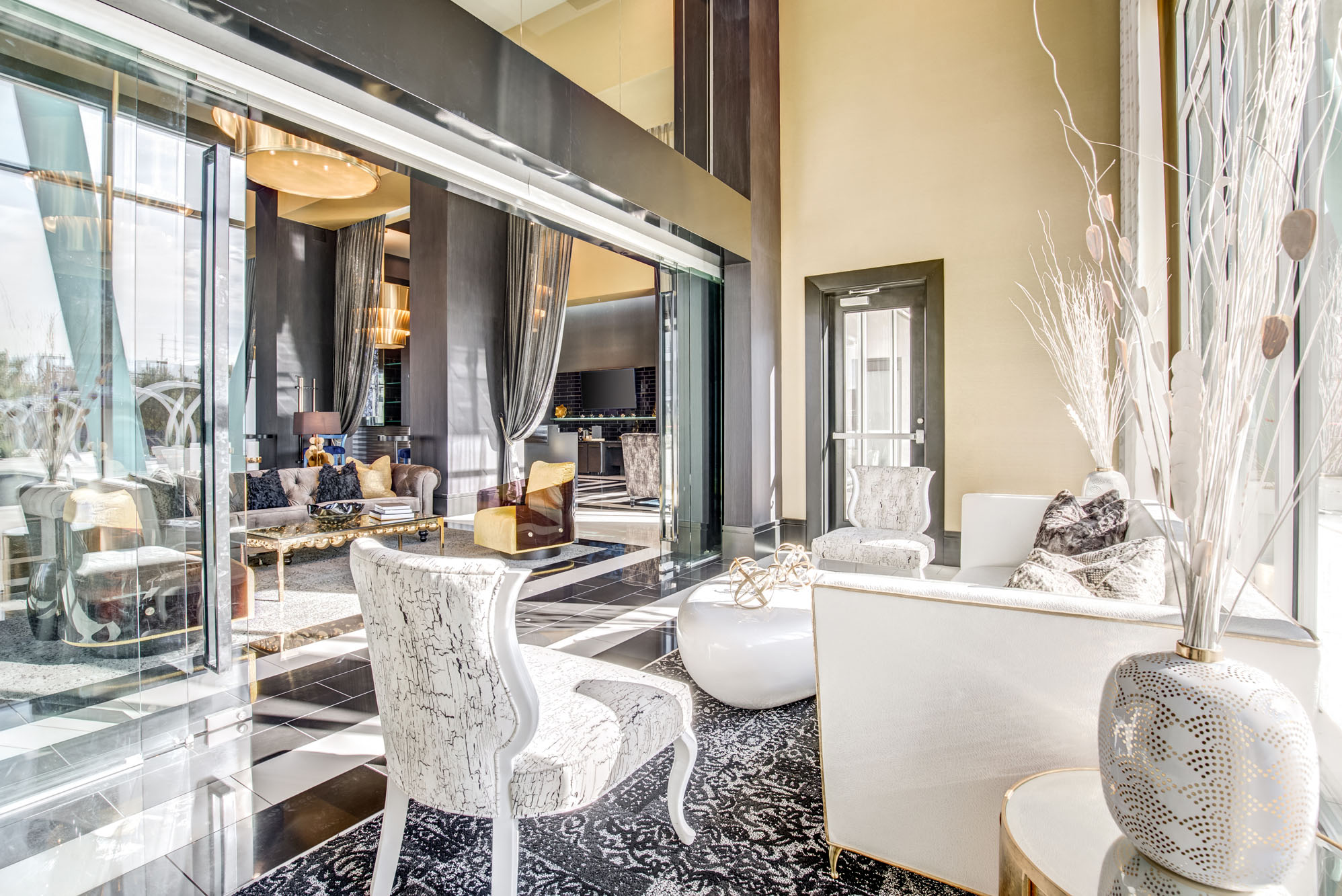 a living room with white furniture and a large window