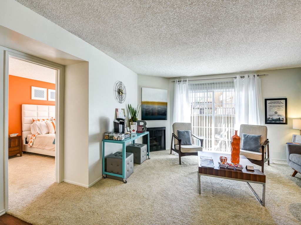 a living room with a couch and a table and a fireplace