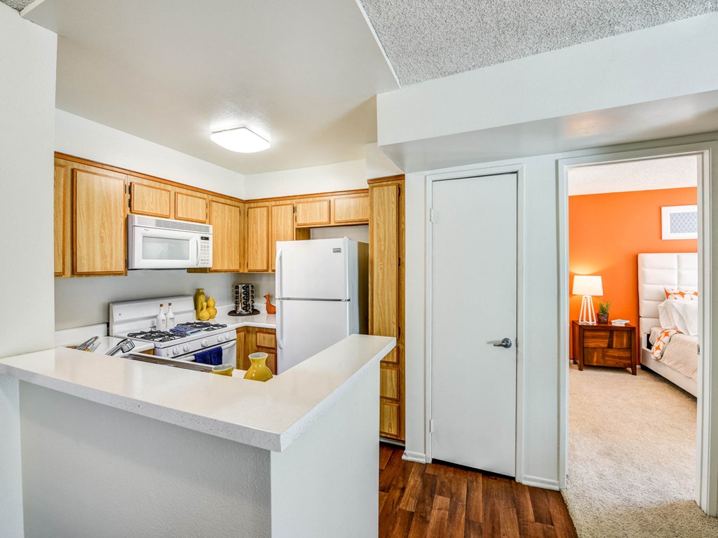 a kitchen with white appliances and a white refrigerator