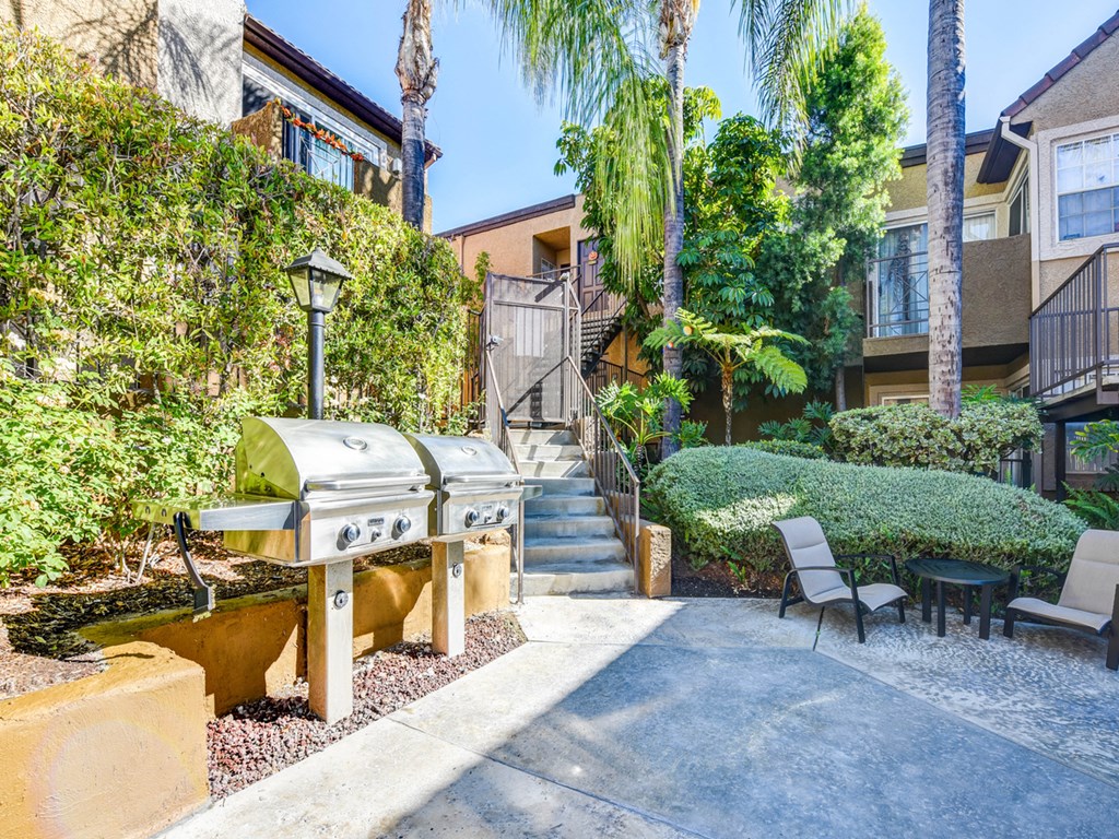 a backyard with a barbecue grill and a staircase