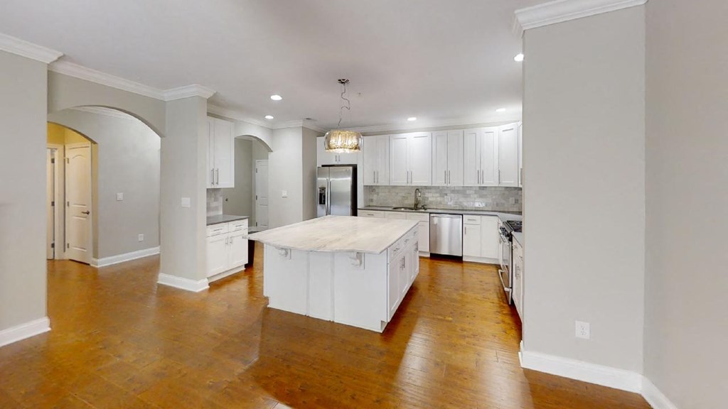 a kitchen with a large island in the middle of it