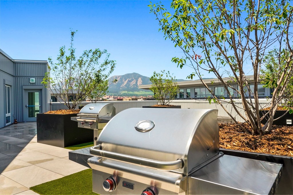 a bbq grill on the rooftop patio of Platform with mountain views