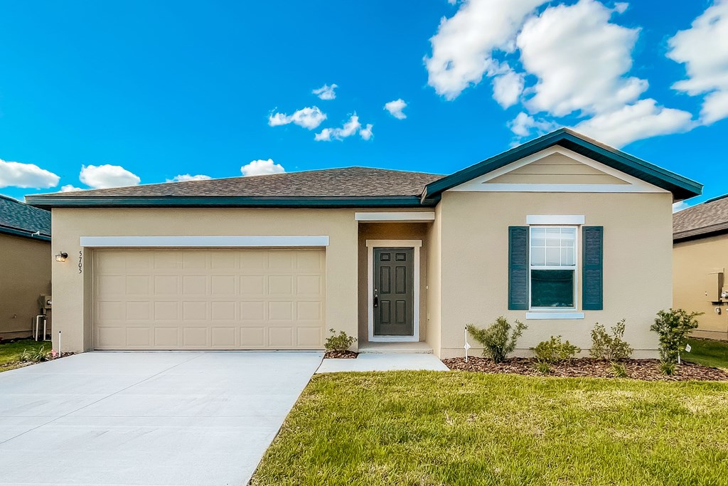 A house with a garage door and a brown door.