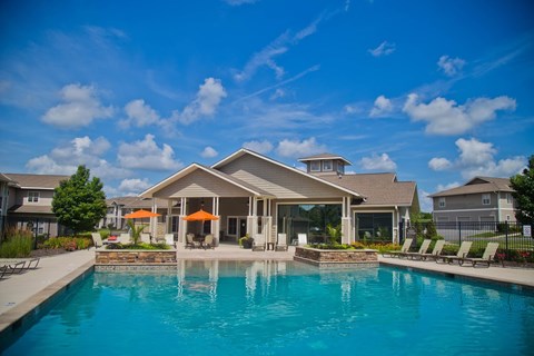 A large house with a pool in front.