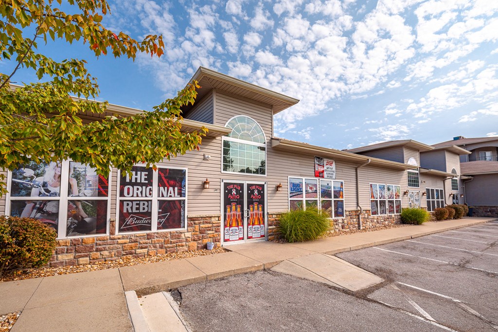 the front of the office mall building with posters on the windows