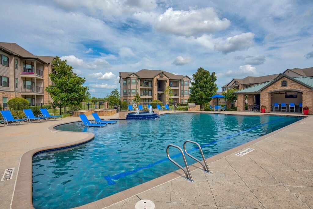 swimming pool surrounded by beach chairs
