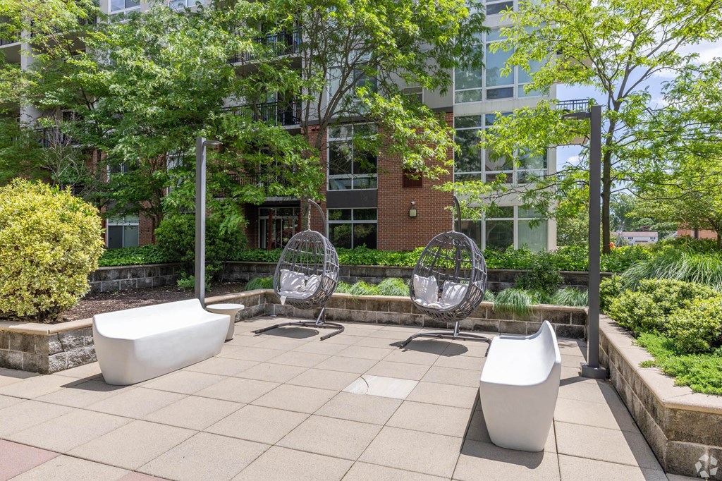 two urinals and two chairs on a patio