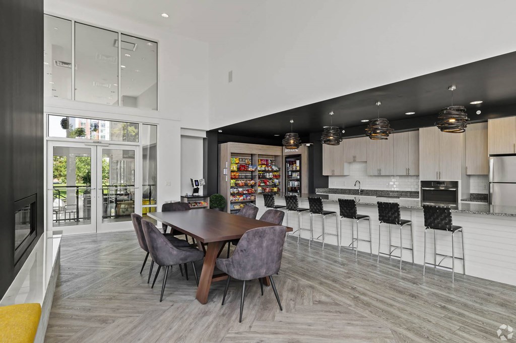 a dining room with a table and chairs and a kitchen