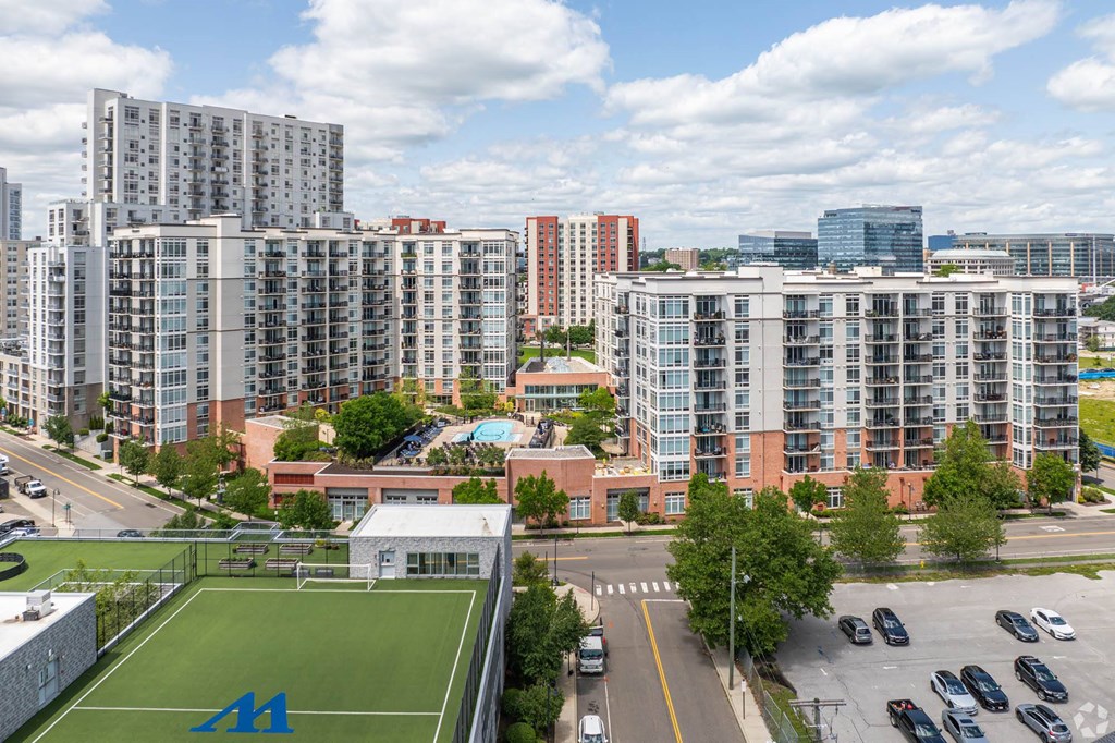 an aerial view of the city with a soccer field and a park