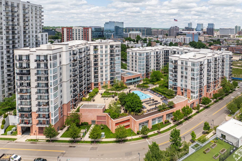 an aerial view of a city with tall buildings and a swimming pool