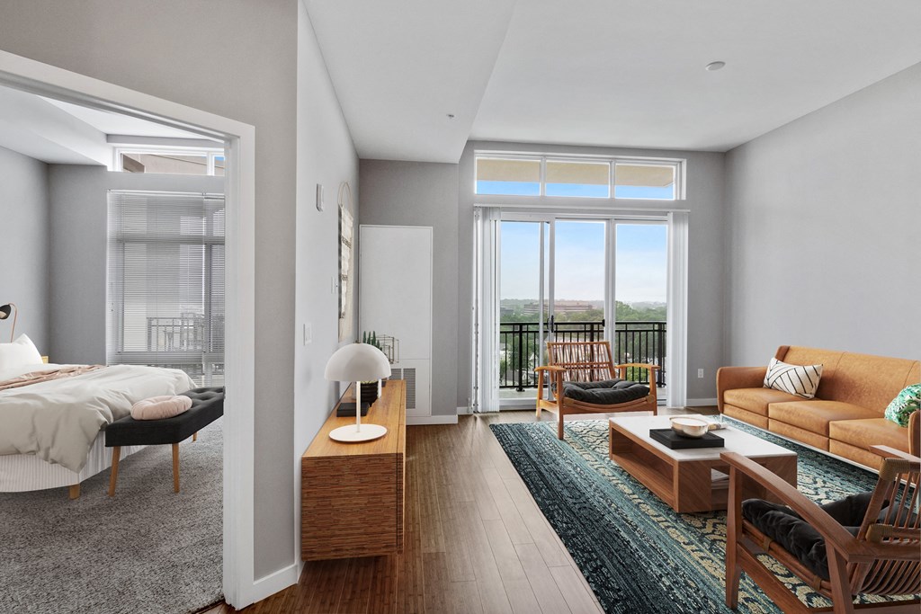 living area and bedroom with modern furnishings and windows