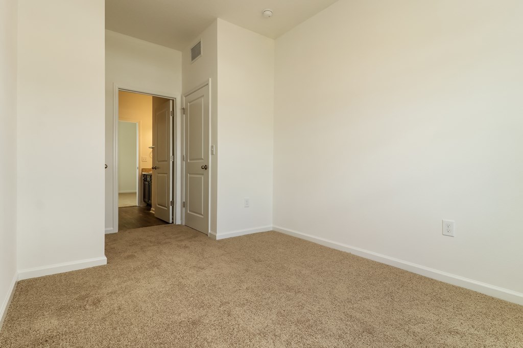 A room with carpeted floor and white walls.