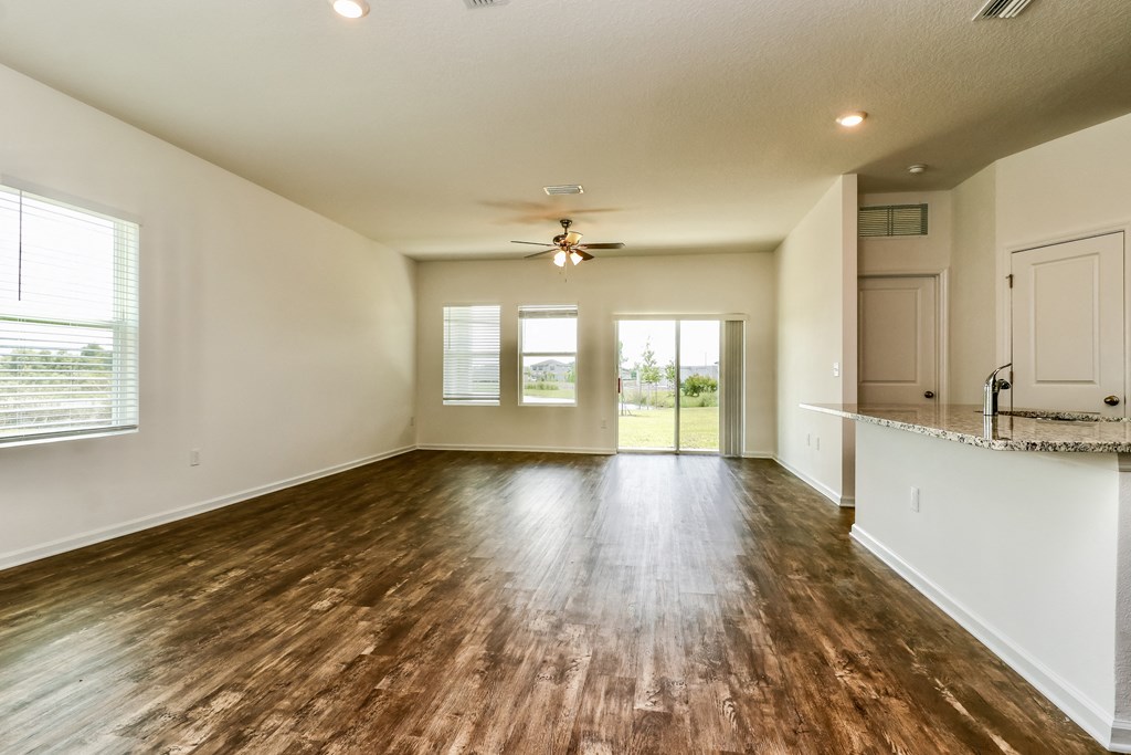 A room with wooden floors and a ceiling fan.