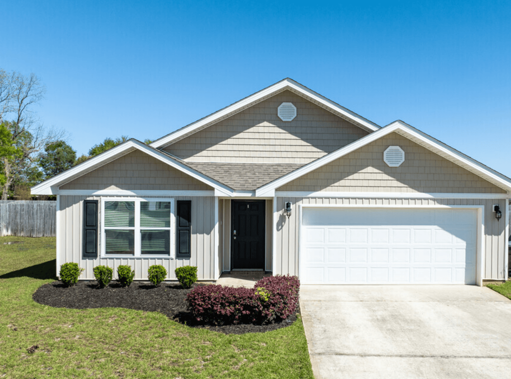 a house with a white garage door and a lawn