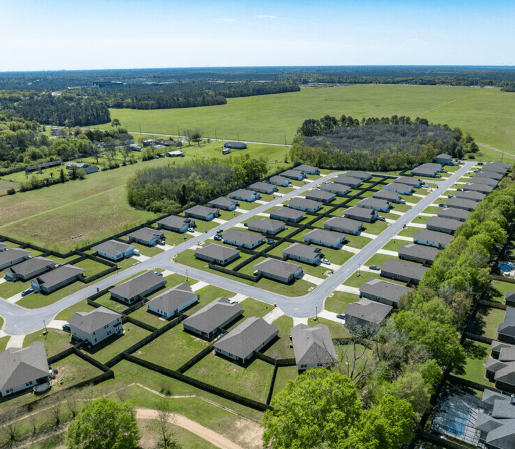 an aerial view of a neighborhood with many houses and trees
