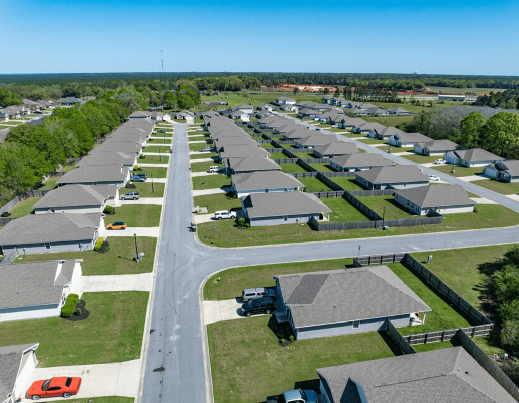 an aerial view of a row of houses in a parking lot
