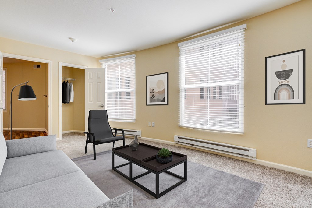 an empty living room with a couch and a coffee table