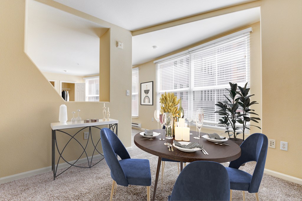 a dining room with a table and chairs and a large window