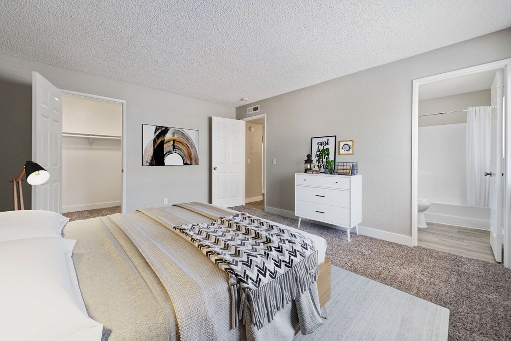 a bedroom with a large bed and a closet