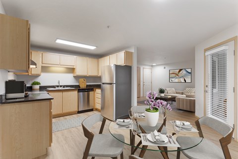 A modern kitchen with a dining table set for two.