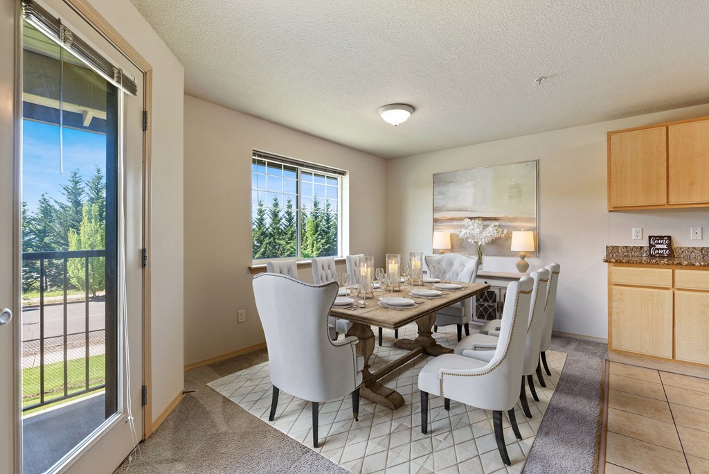 a dining room with a table and chairs and a sliding glass door