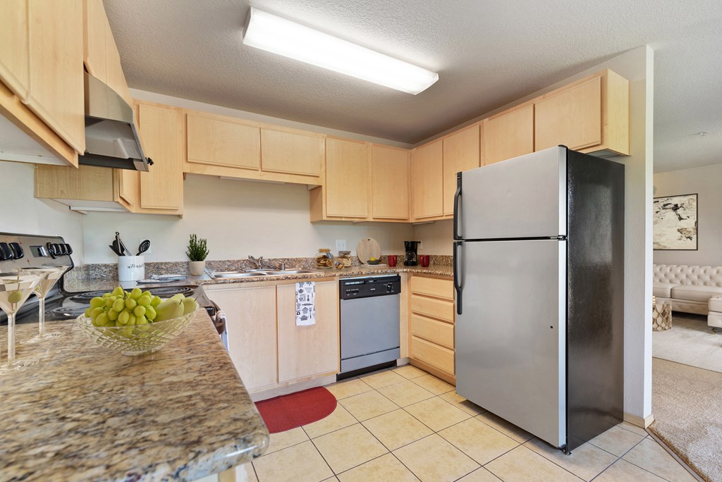 Vancouver, WA, Apartments for Rent - Reflections at the Park - Sleek Gourmet Kitchen with Maple Cabinets, Stainless Steel Appliances, and Granite Countertops