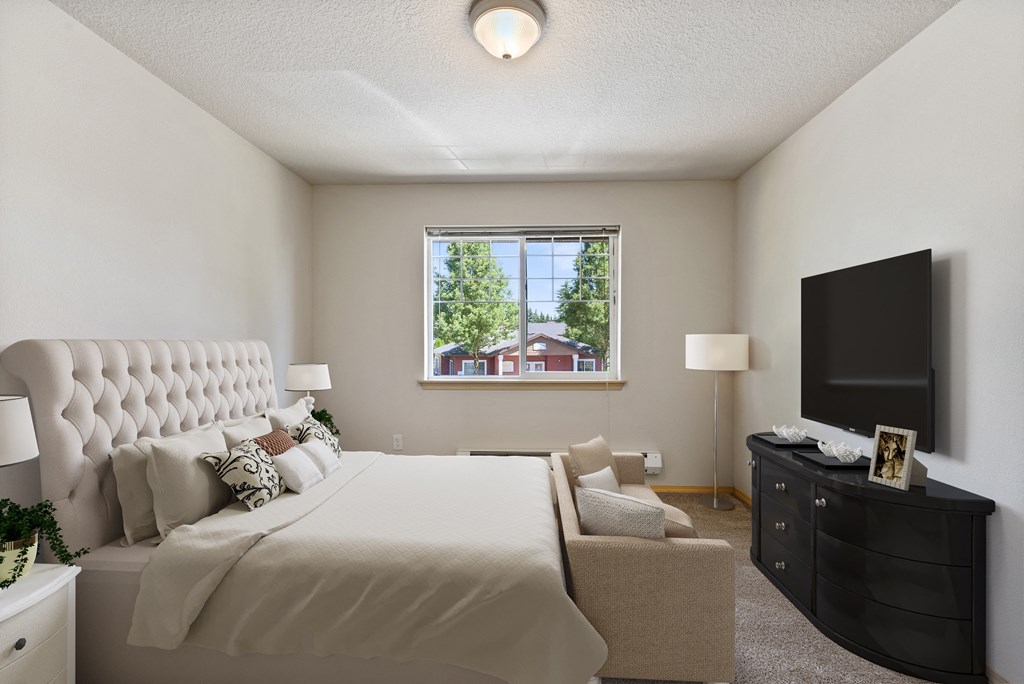 a bedroom with a large bed and a large window