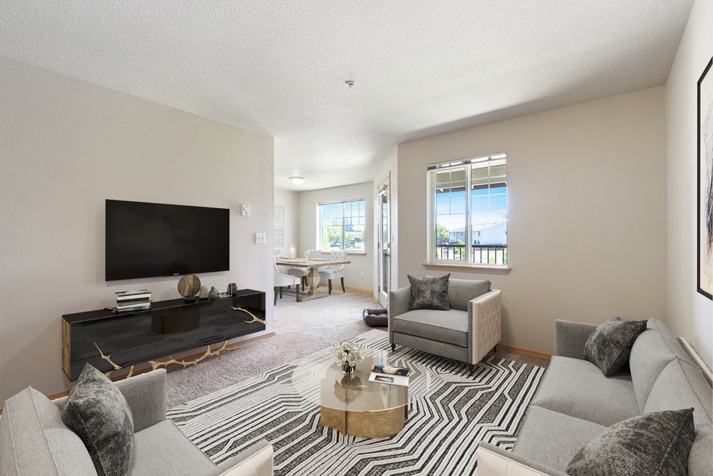 a living room with a couch and a chair and a television