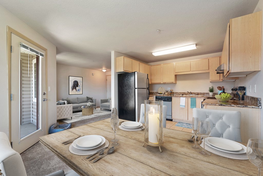 a living room and kitchen with a wooden table and chairs