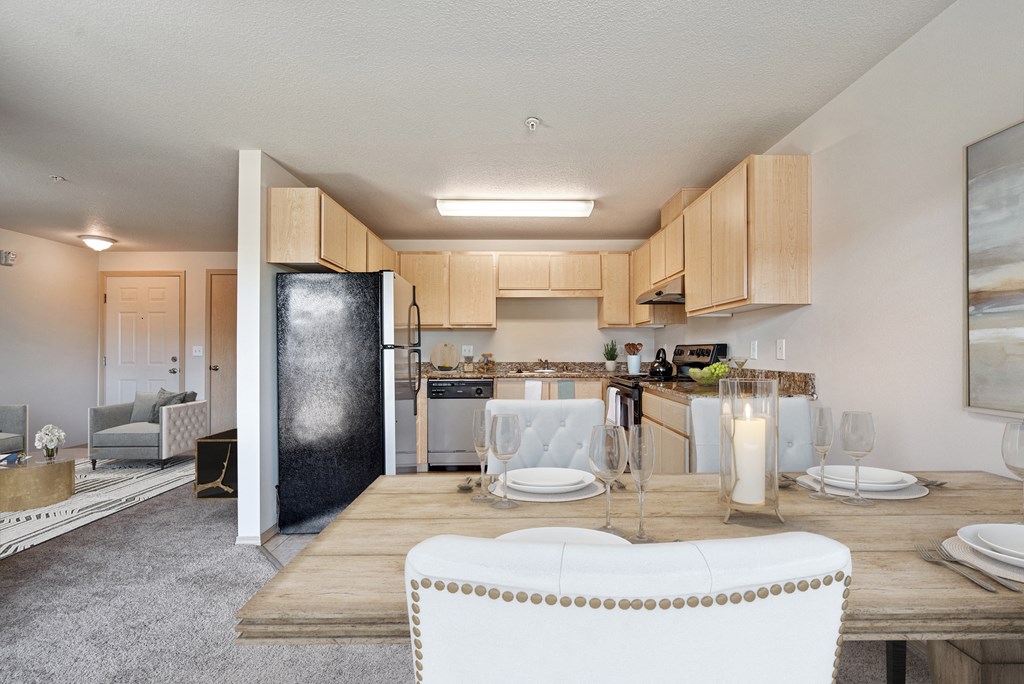 an open kitchen and living room with a dining table and chairs
