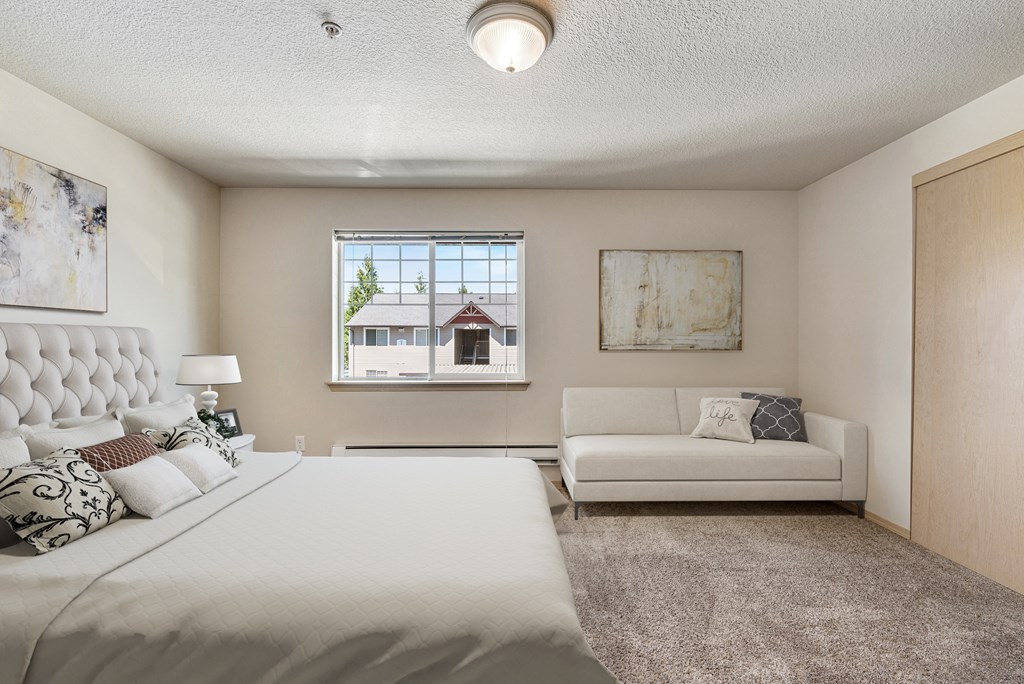 a bedroom with a large bed and a couch