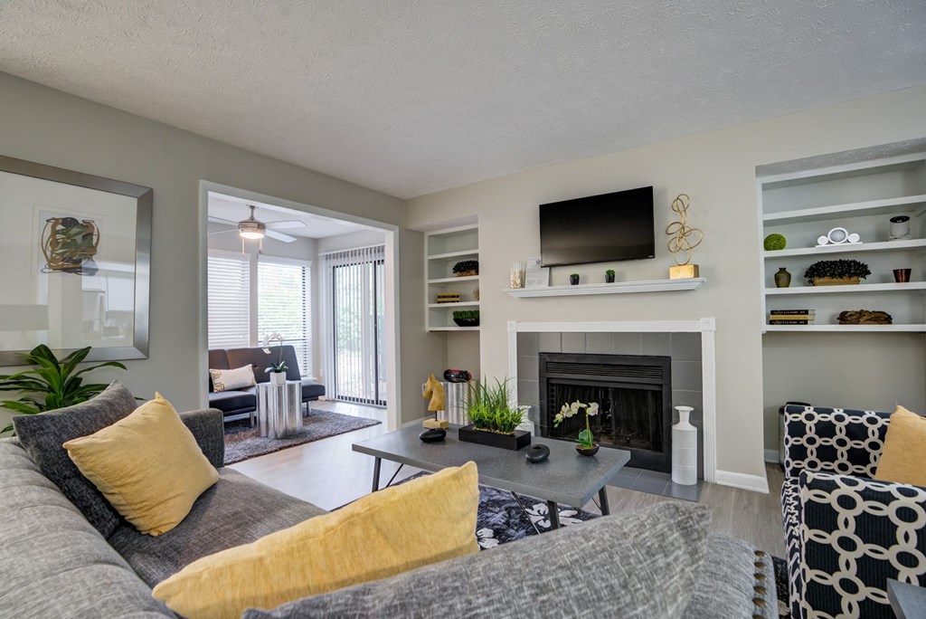 a living room with a gray couch and a fireplace