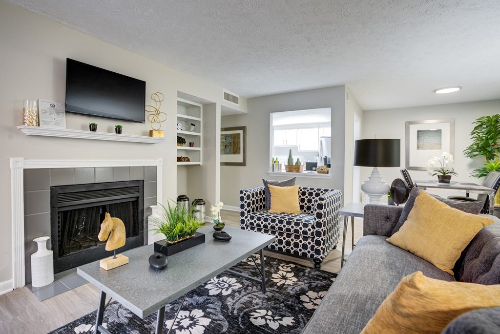 a living room with a fireplace and a tv
