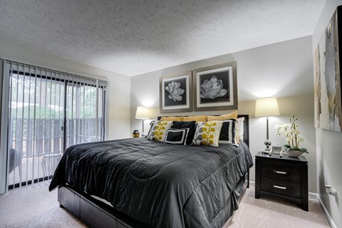 Bright bedroom in Raleigh, NC apartment at Remington Place with sliding glass doors and open layout