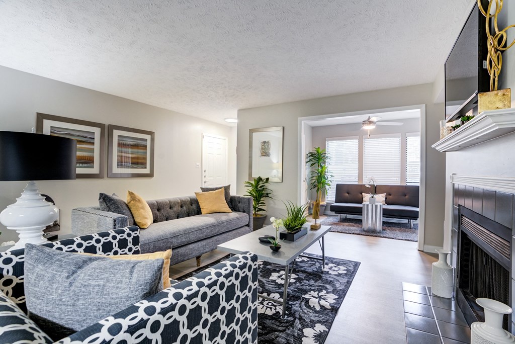 an open living room with couches and a fireplace