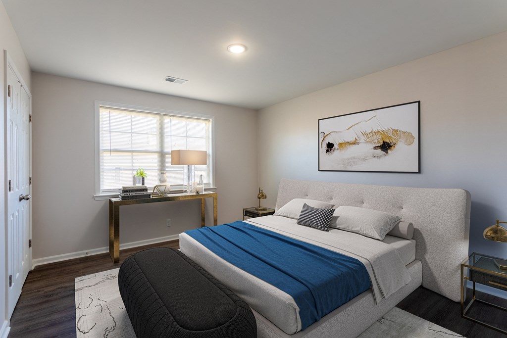 a bedroom with a white bed and a blue blanket