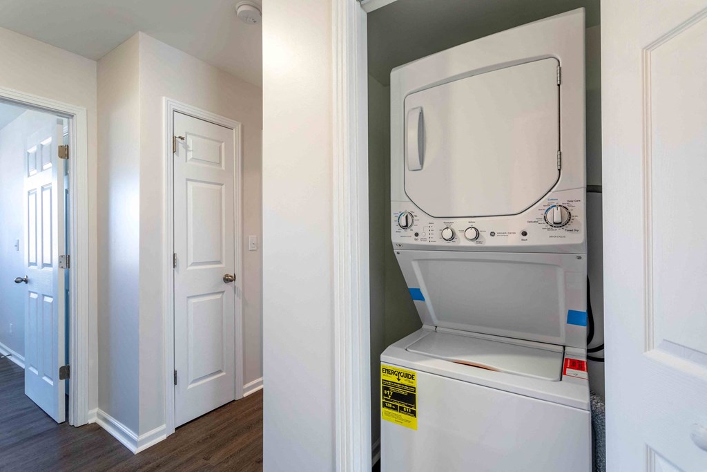 a white washer and dryer in a laundry room with a door