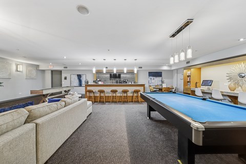 Resident lounge with billiards table and comfortable seating at River 595