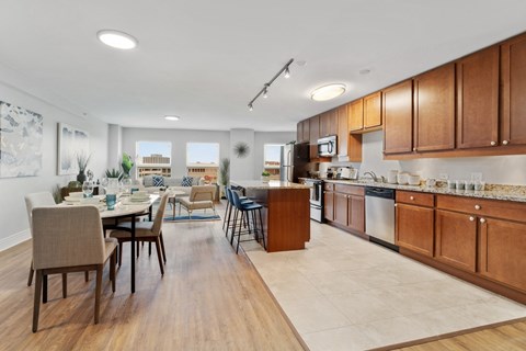 A kitchen with a dining table and chairs.
