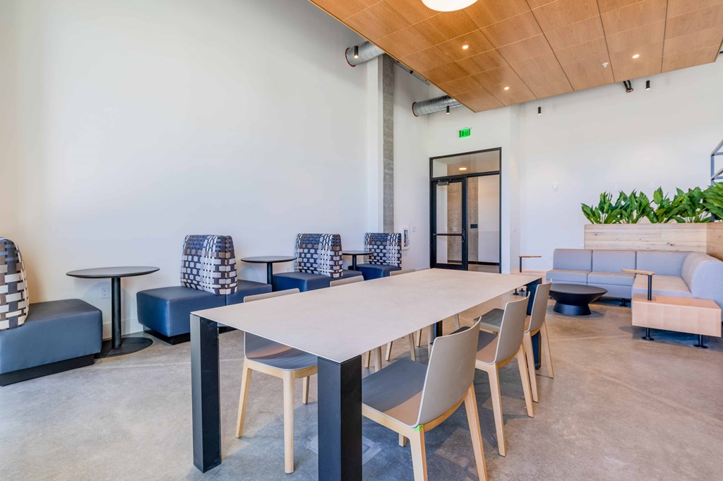 a communal area with a long table and chairs in a lobbyat Riverfront Everett, Everett, WA