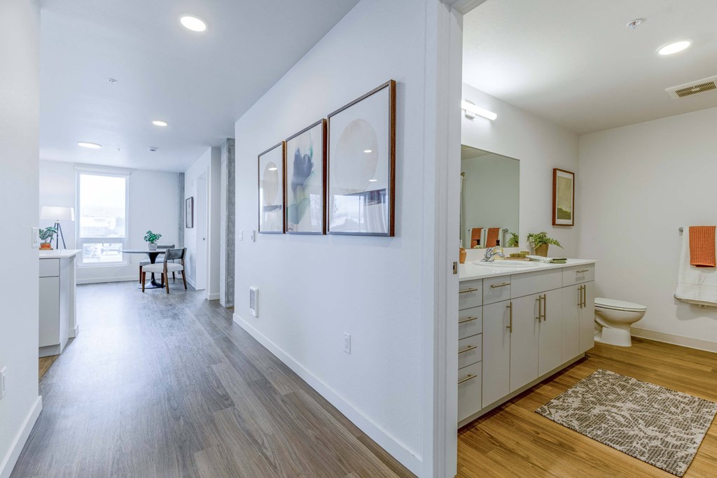 a hallway with a bathroom and a living room with a sink and a toilet at Riverfront Everett, Everett, WA